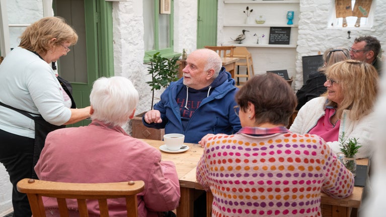 4 visitors sat at a table in the tearoom with a